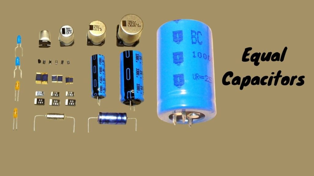 Image of equal capacitors alongside various electronic components on a workbench.
